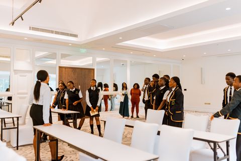 Learners in school uniform visiting a hall at the hotel venue