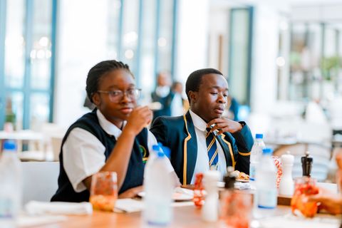 Uniformed learners sharing a meal at the hotel
