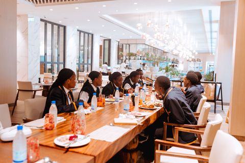 Uniformed learners and staff sharing a meal during the off-campus hotel outing