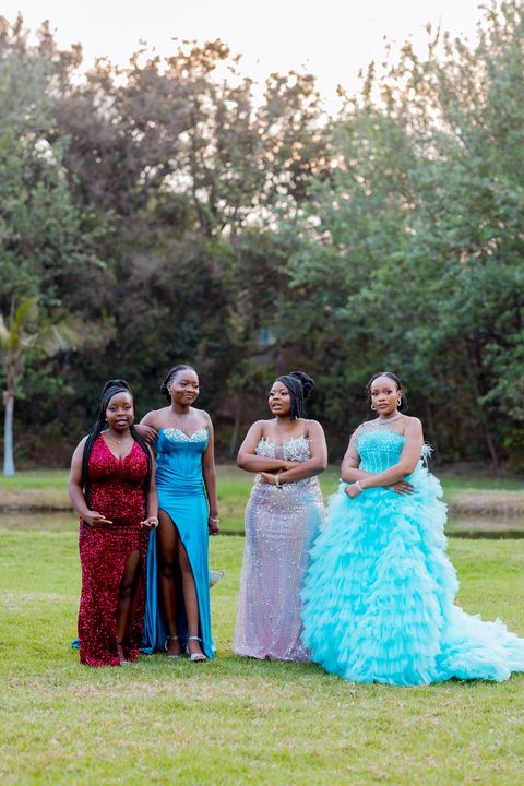 Prom guests posing together in the venue gardens