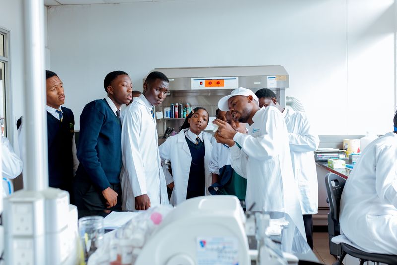 Firm Foundation learners observing a demonstration during an off-campus CIMAS laboratory visit
